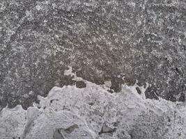 Grungy wall of gray concrete texture with cracked surface from sand and cement materials. photo