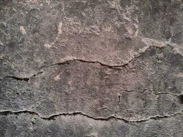 Grungy wall of gray concrete texture with cracked surface from sand and cement materials. photo