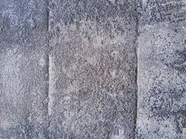 Grungy wall of gray concrete texture with cracked surface from sand and cement materials. photo