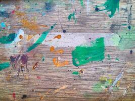 Abstract painting of a brush strokes on stained wood texture photo