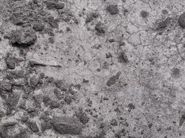 Grungy wall of gray concrete texture with cracked surface from sand and cement materials. photo