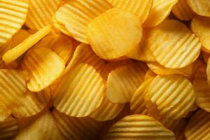 Crispy potato chips viewed from the top, forming a textured background AI Generated photo