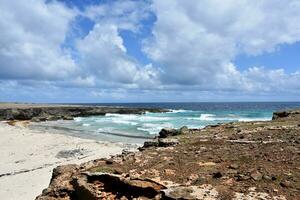 Cove with Waves Crashing Ashore in Aruba photo