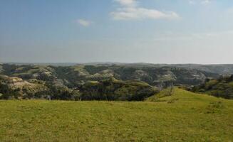 Lush Rugged Landscape with Rolling Hills and Canyons photo