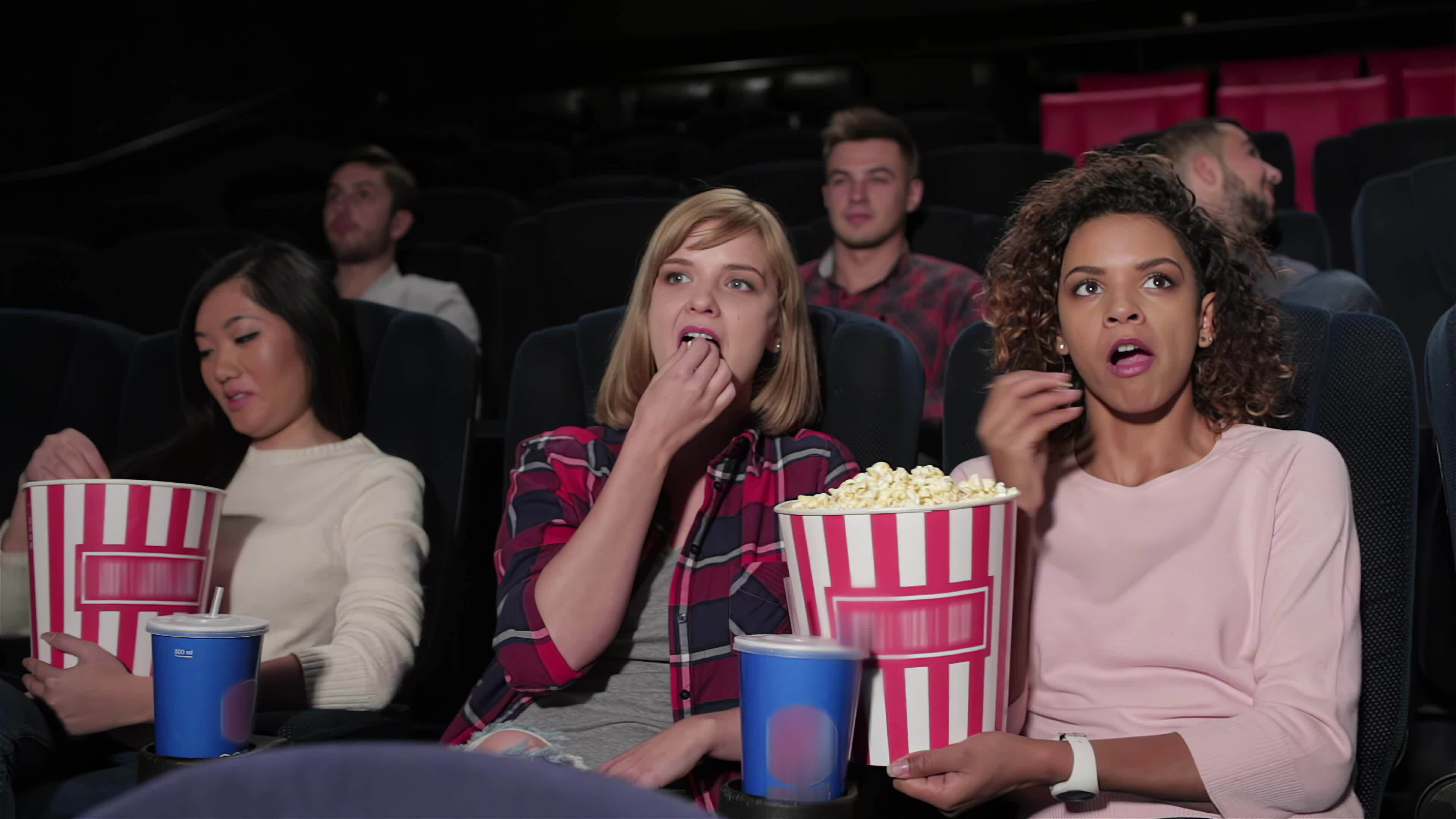 Group of young people sitting in multiplex 34091000 Stock Video at Vecteezy