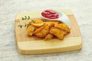 Fried rustic potato with tomato ketcup photo