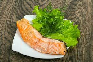 Steamed salmon over wooden background photo