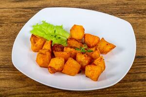 Baked potato over wooden background photo