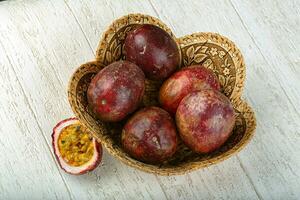 Passion fruit over wooden background photo