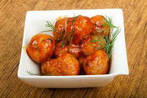 Meat balls over wooden background photo