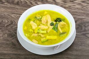 Green curry over wooden background photo