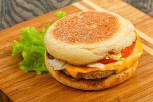 Cheeseburger over wooden background photo