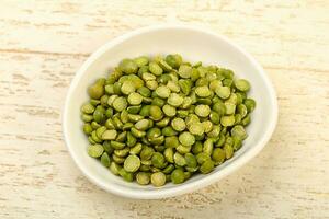 Green peas over wooden background photo