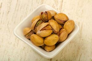 Pistachio over wooden background photo