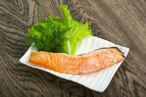 Steamed salmon over wooden background photo