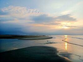 View of the sunset on the beach in Balinggi Jati Village, Parigi Moutong Regency, Central Sulawesi photo