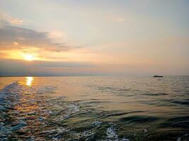 View of the sunset on the beach in Balinggi Jati Village, Parigi Moutong Regency, Central Sulawesi photo