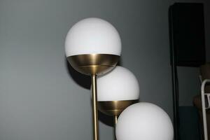 Light luxury table lamp with three white bulbs photo