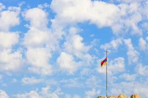 Armenian flag and blue sky with white clouds photo