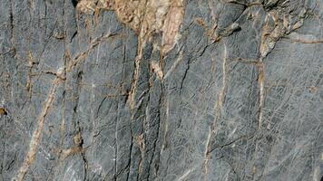 a close up of a rock with cracks and cracks photo