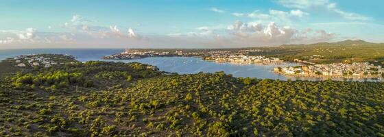panoramic aerial view at sunrise, fishing port, typical area of tourist interest, holiday destinations and hotel zone.Portocolom, Majorca, Balearic Islands photo