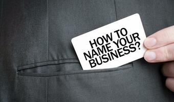 Card with HOW TO NAME YOUR BUISINESS text in pocket of businessman suit. Investment and decisions business concept. photo