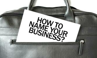 Text HOW TO NAME YOUR BUISINESS writing on white paper sheet in the black business bag. Business concept photo