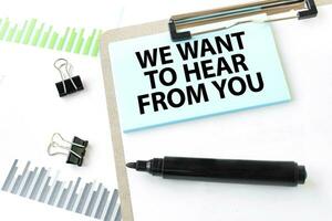 Paper plate, marker, diagram, chart and office tools. Text WE WANT TO HEAR FROM YOU photo