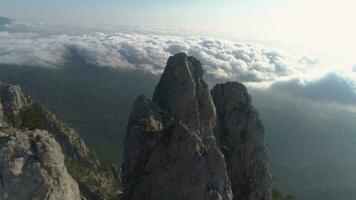 Ai-Petri rocky mountain above the clouds at sunny day. Aerial view. video