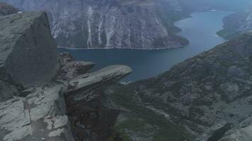 Trolltunga Cliff in Norway. Famous Troll Tongue Rock in Summer Day. Aerial View. Drone is Flying Around video