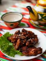 fried Chicken drumsticks in an oriental sauce. Eastern cuisine photo