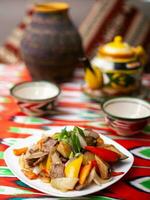 Fried beef meat in oil with potatoes, onions, bell peppers according to the Uyghur recipe photo