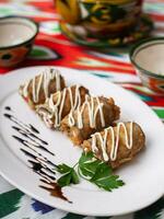 Fried eggplant rolls in breading stuffed with meat and vegetables. Asian style photo