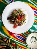 warm salad of green and red peppers, meat, eggplant, onions and tomatoes Asian style photo