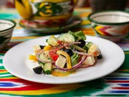 warm salad of green and red peppers, cheese, eggplants, onions and tomatoes Asian style photo