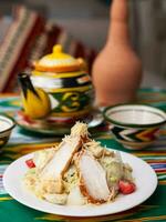 Caesar salad with chicken breast, herbs and cheese. Asian style photo