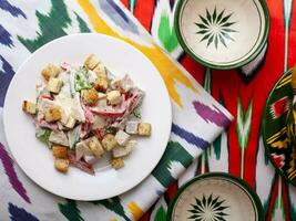 Malibu salad with crab sticks and croutons, feta cheese and vegetables. Asian style photo