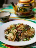 Fried potatoes with pieces of meat. Asian style photo