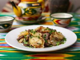 Fried potatoes with pieces of meat. Asian style photo