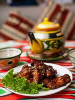 fried Chicken drumsticks in an oriental sauce. Eastern cuisine photo