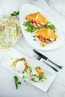 canapes on black bread with cheese, red fish, herbs and cucumber top view photo