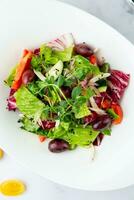 salad of greens, lettuce leaves, cucumbers, pink onions, top view photo