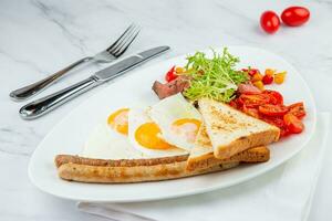 scrambled eggs with vegetables, cherry tomatoes, bread, herbs and sausages on a white plate side view photo