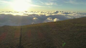 Woman is running above pink clouds and rising hands. Aerial view. video