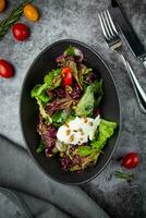 salad with lettuce, radishes, tomatoes, parsley, seeds and cheese top view photo