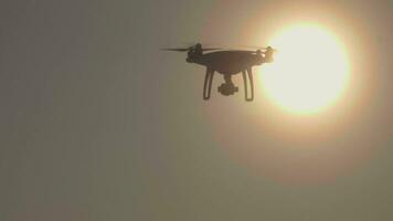 Drone is flying to the right and overlapping the sun. Aerial close-up view. Slow motion. video