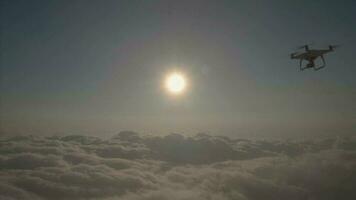 Drone is flying to the sun above clouds. Aerial view. Slow motion. video