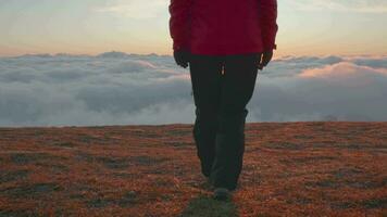 joven mujer es caminando encima nubes a amanecer video