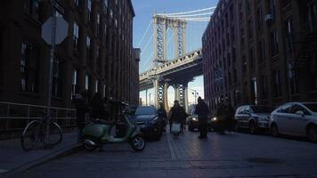 NEW YORK CITY, USA - NOVEMBER 22, 2018 Manhattan Bridge and Brooklyn Neighborhood. DUMBO district with Tourists. Slow Motion. Steadicam Shot, Moving Sideways video