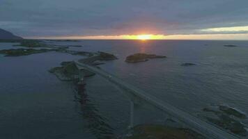 Atlantic Ocean Road in Norway and Cars at Summer Sunset. Aerial View. Drone is Orbiting Around video